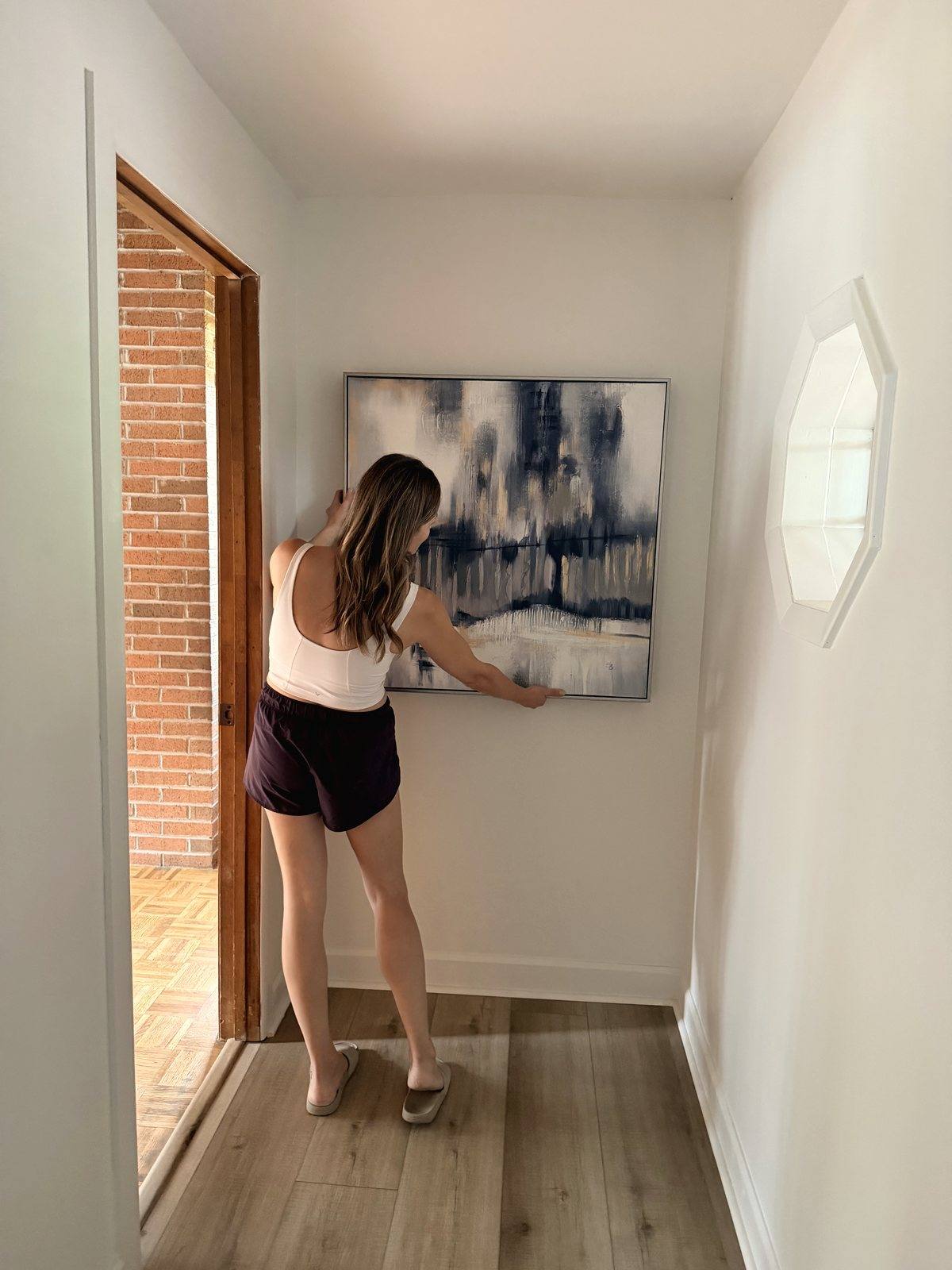 Hanging artwork in a finished hallway