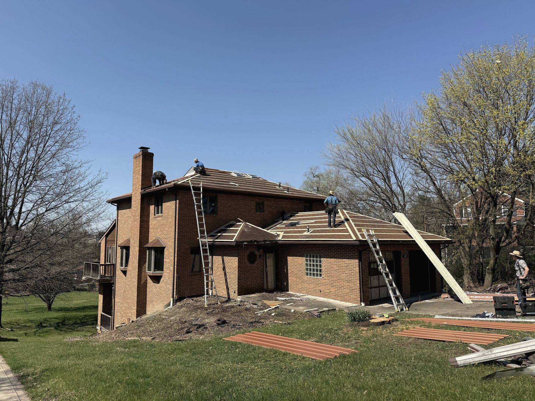 Crew replacing the roof on a brick house in Pittsburgh